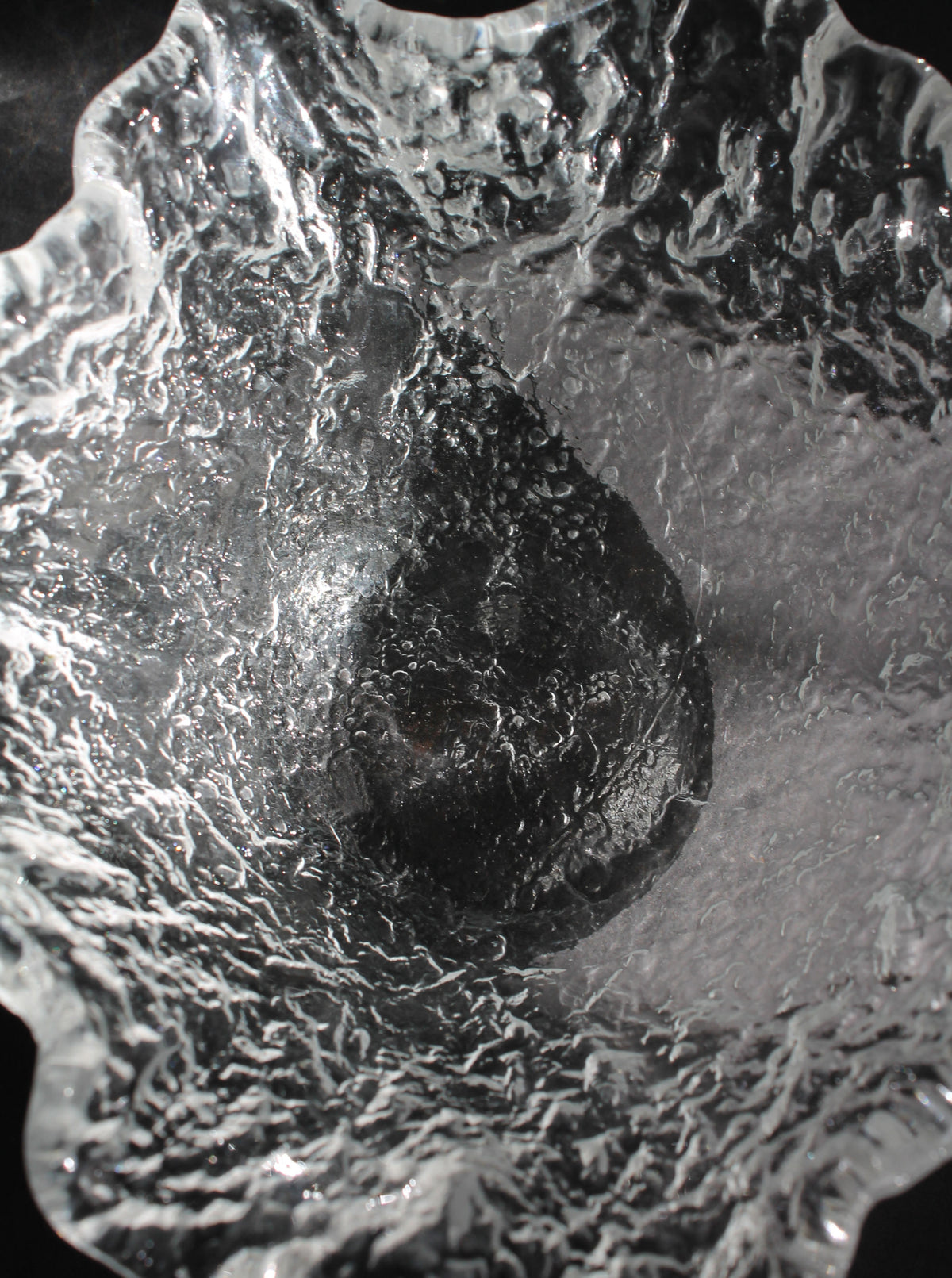 Crystal glass bowl interior showing organic sculptural texture and bubbled surface detail