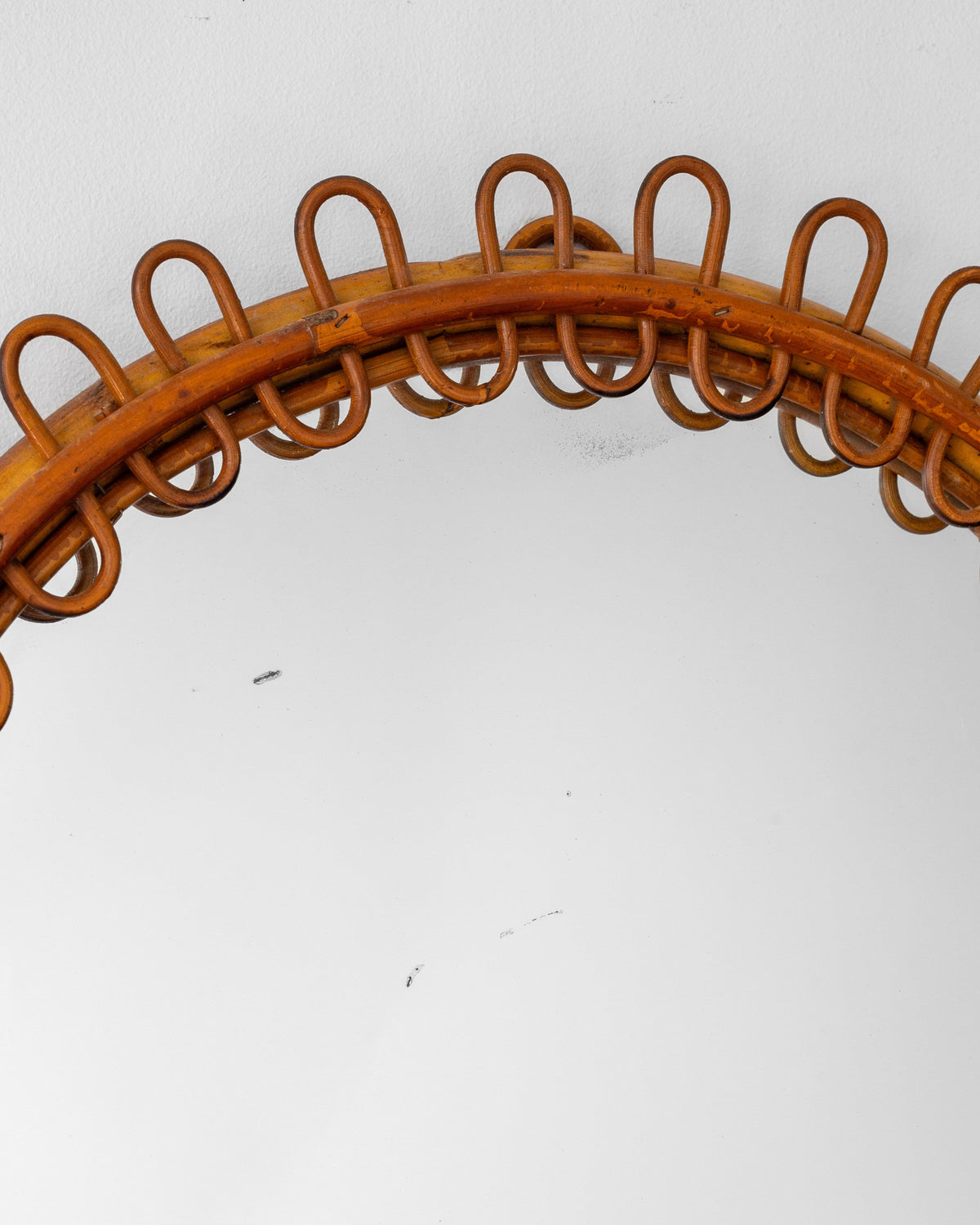 Curved rattan frame detail of Franco Albini mirror with loop design
