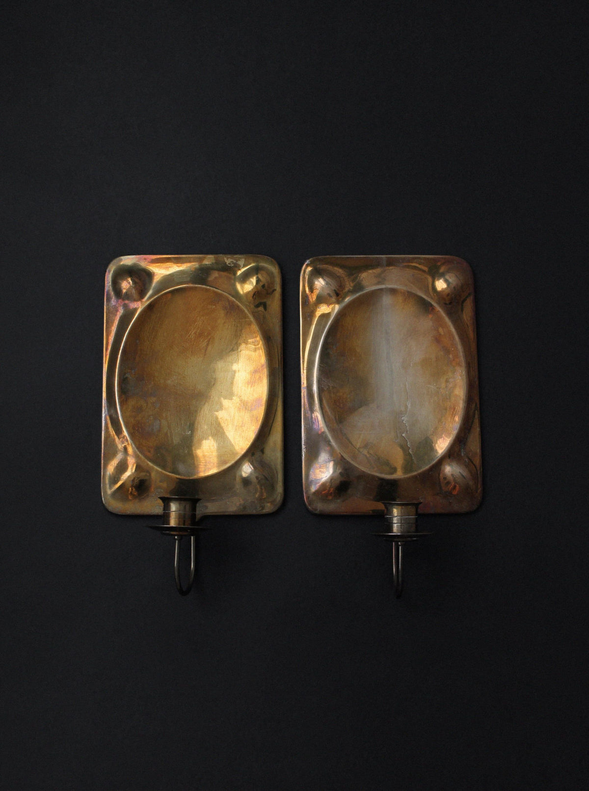 Pair of vintage brass wall sconces with oval reflector detail
