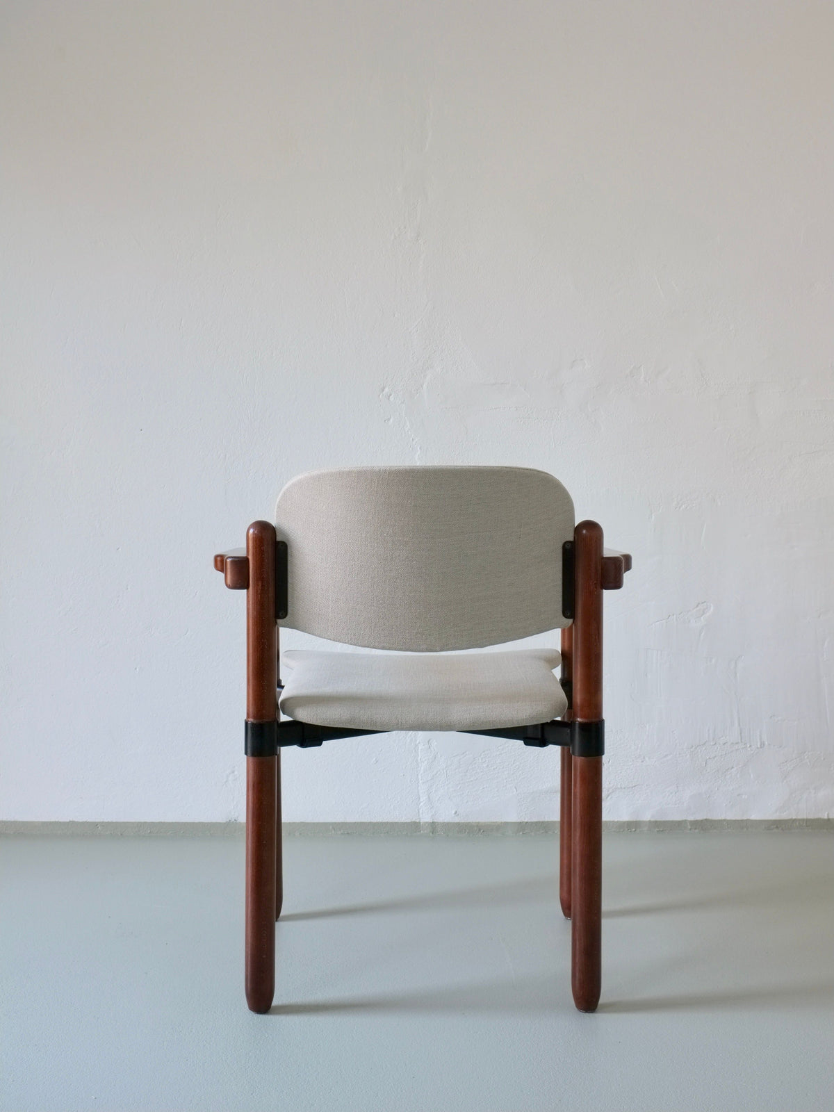 A Set of 4 Armchairs by Fröscher Sitform, Germany 1970s from Veter Vintage features minimalist wooden frames with light beige cushioned seats and backrests, shown against a white wall on a light gray floor.