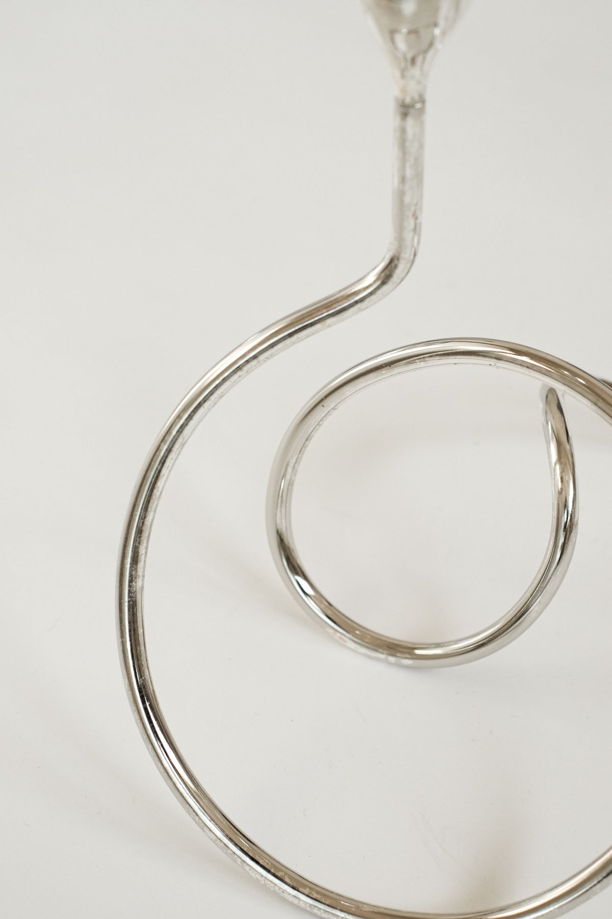 Clear glass Loop candle holder with curved spiral design detail