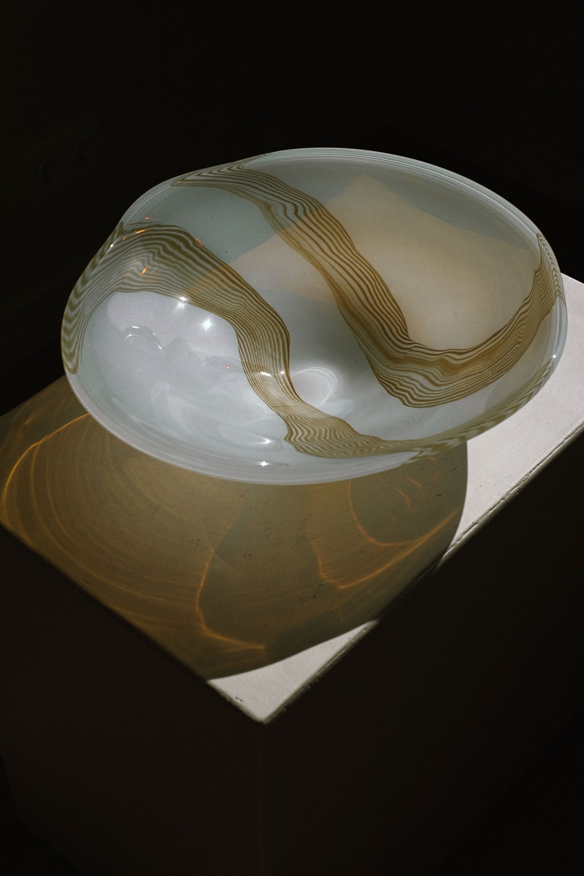Large blown glass bowl with golden swirl patterns, detail view