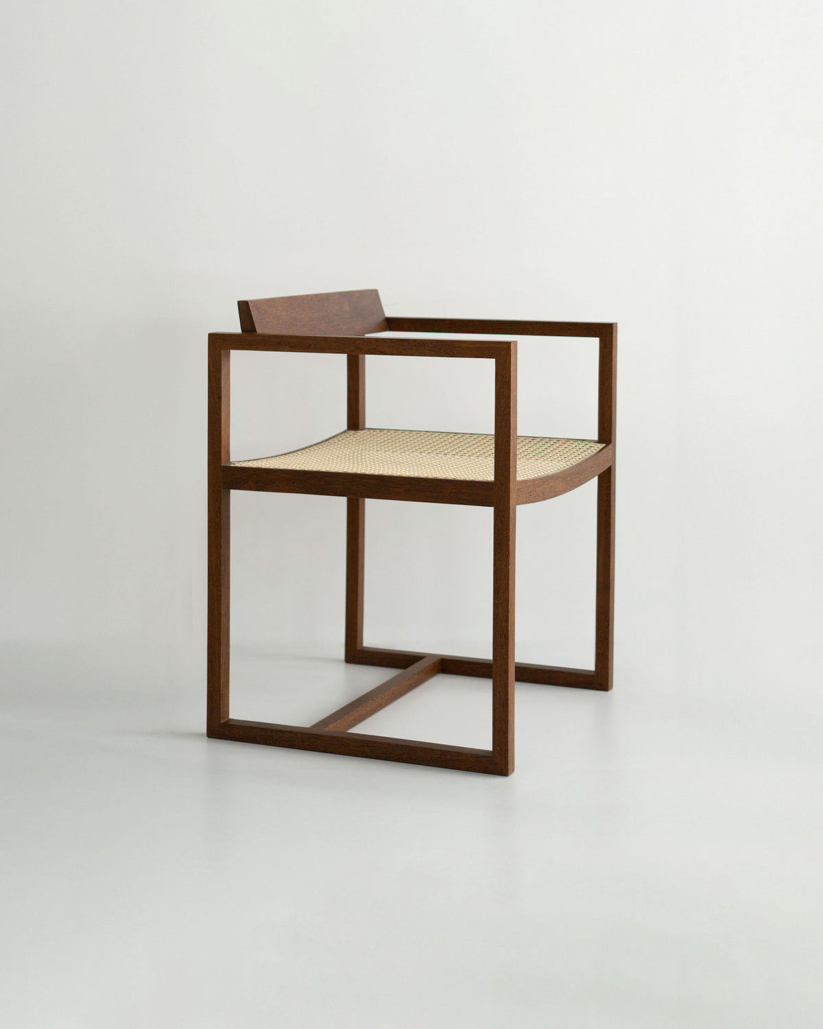 The "Amélia" Armchair by Andre Grippi features a minimalist wooden square frame, straight armrests, and a woven straw seat, displayed against a plain light background.