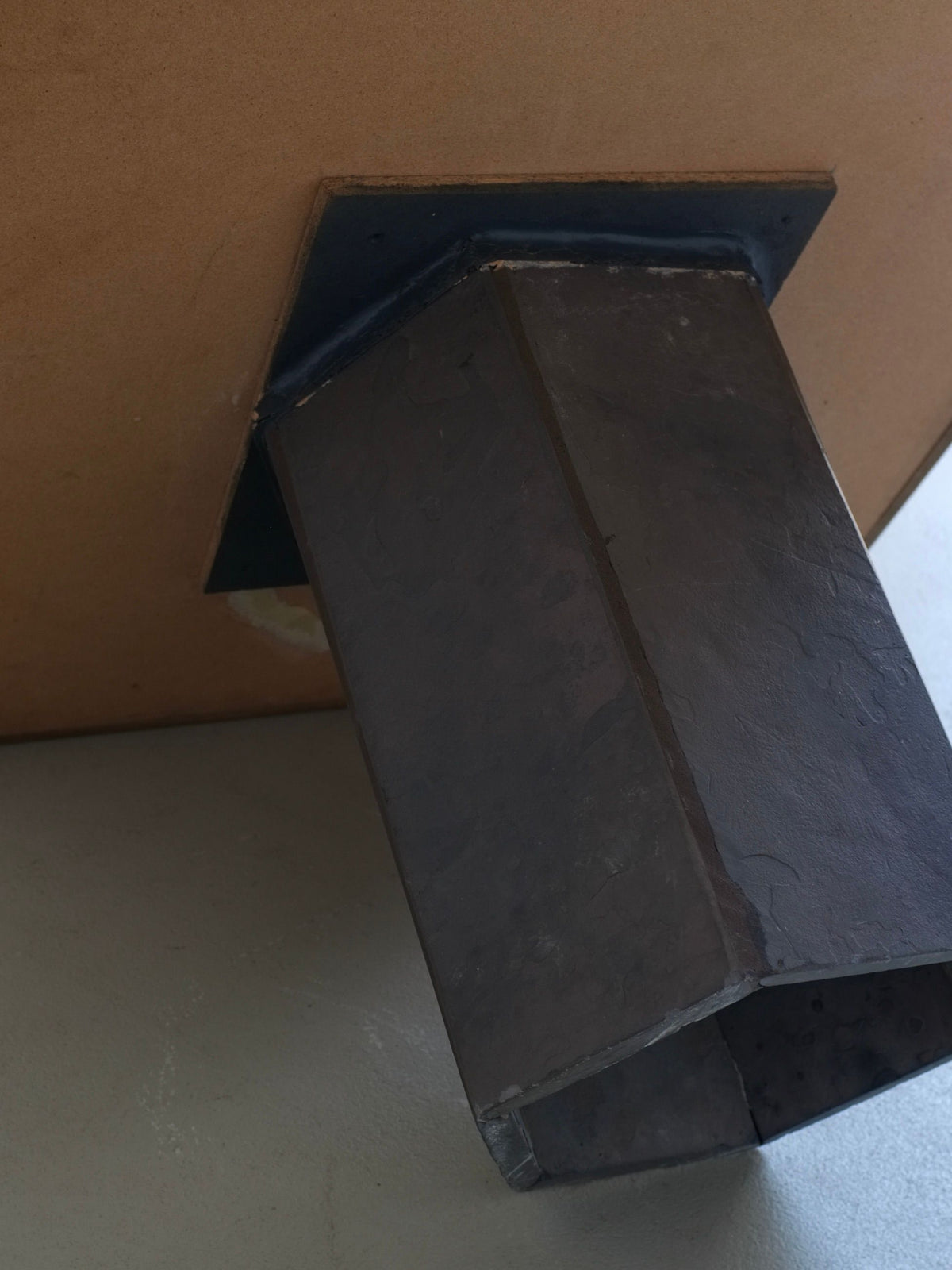 Brutalist oak coffee table angled view showing geometric stone base