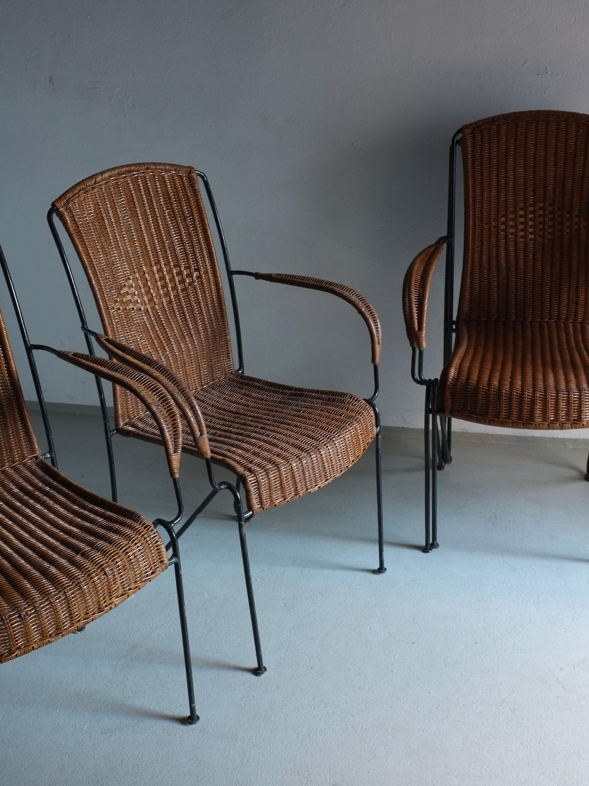 Frederick Weinberg wicker iron armchairs grouped on blue floor