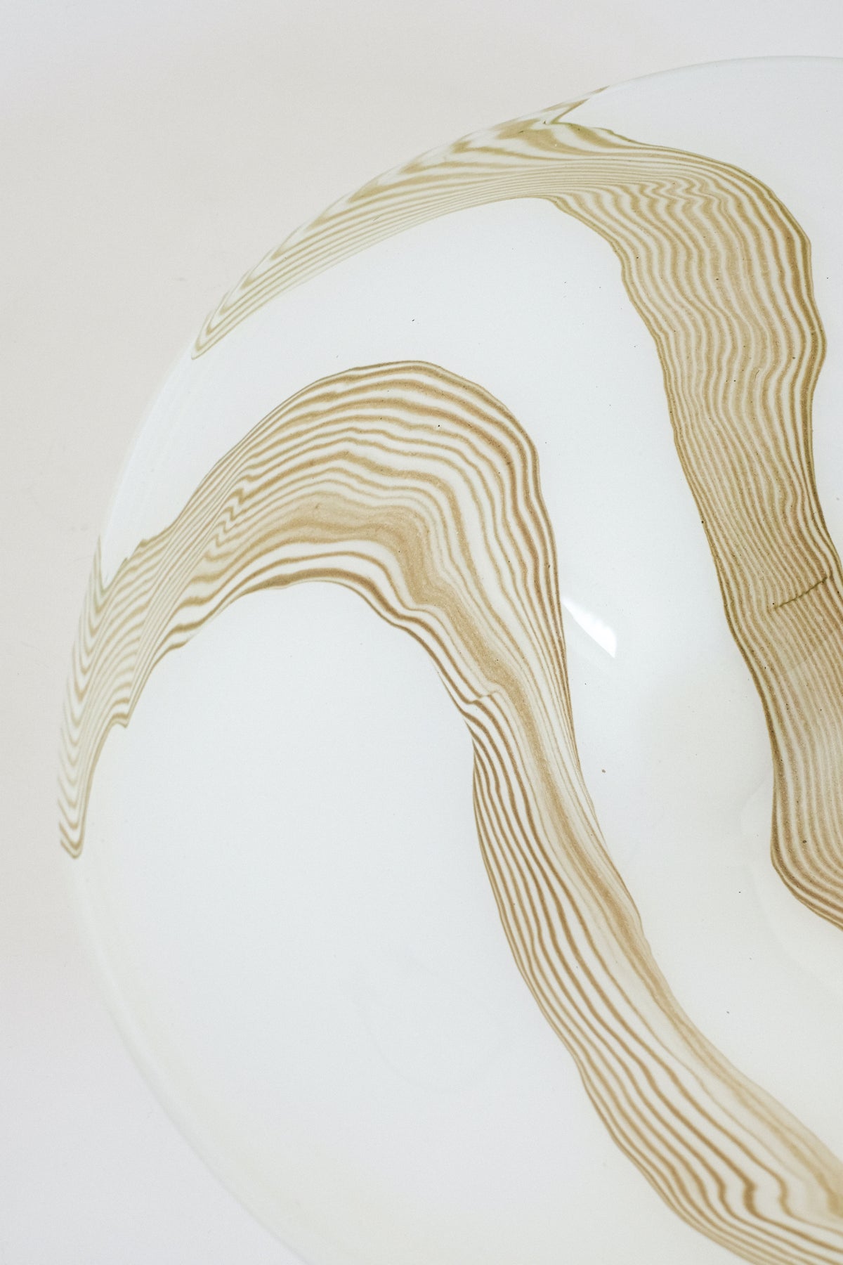 Flowing golden striped pattern detail of large blown glass bowl