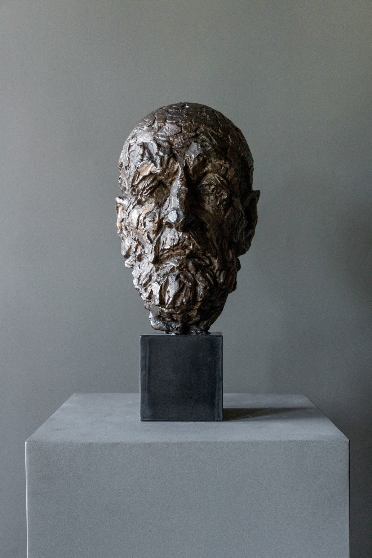 Vintage Bronze Sculpture 60s — close-up of textured bronze face on pedestal