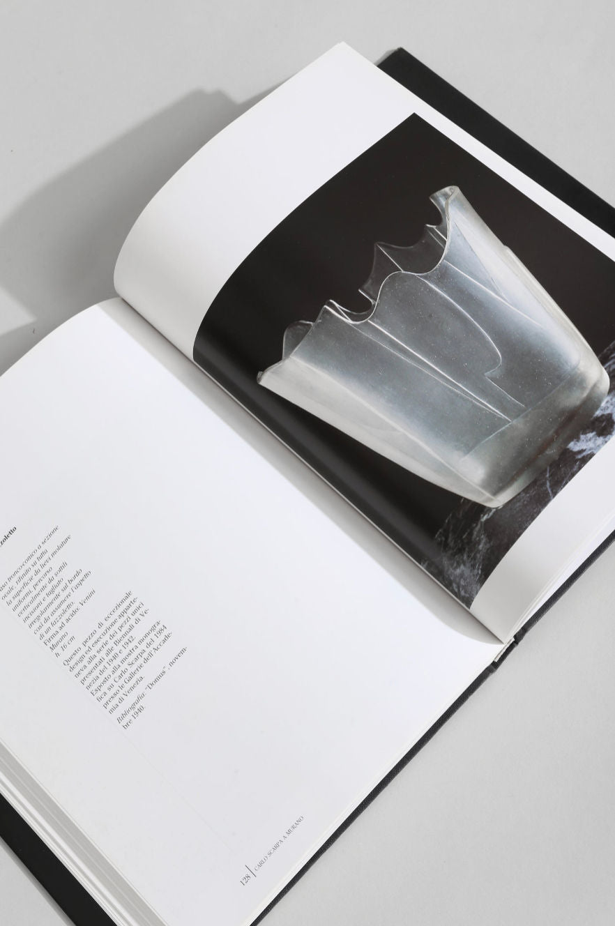 Open Carlo Scarpa Murano glass art book showing crystal vessel page