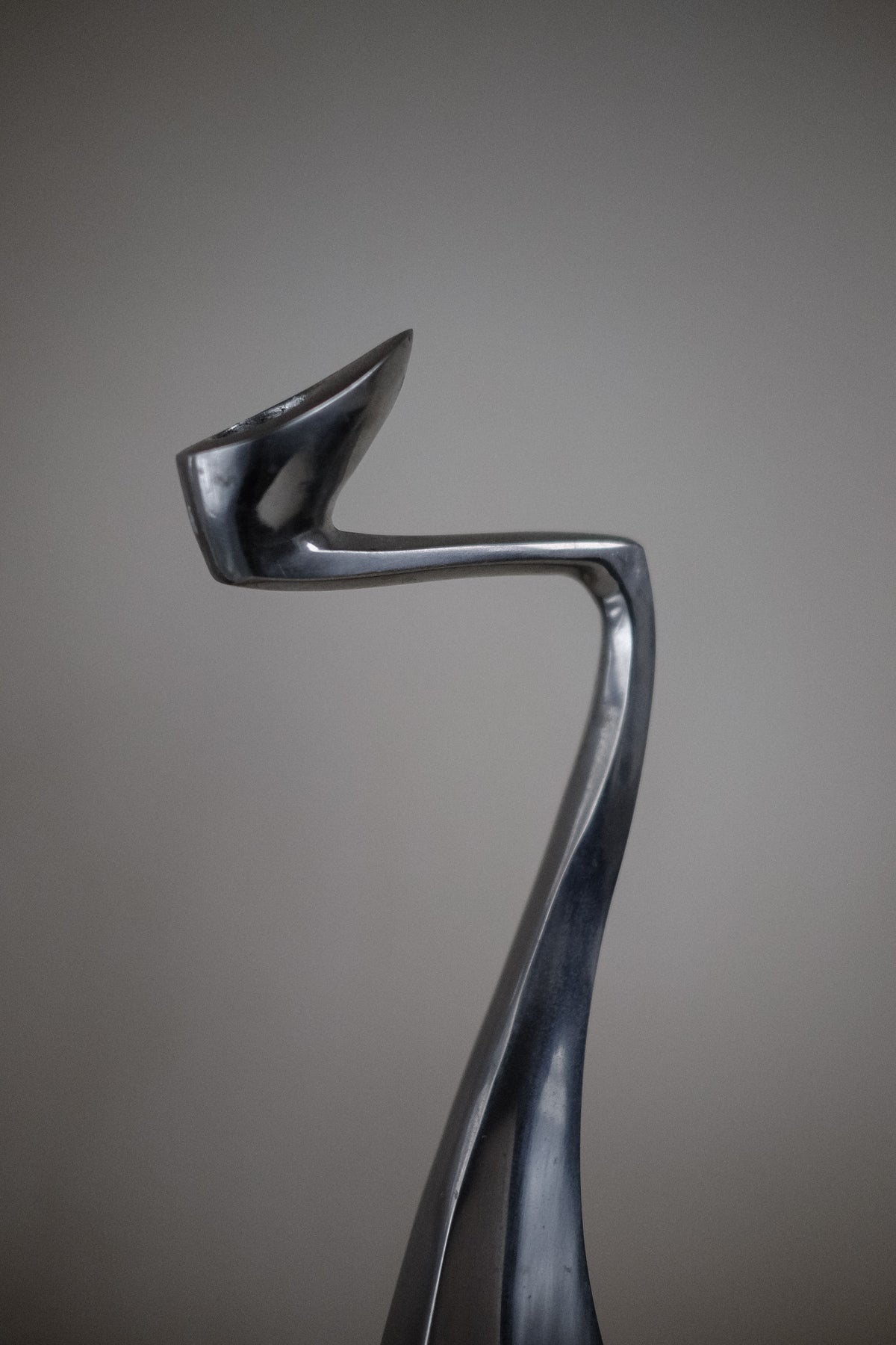 The Pair of Candleholders by Matthew Hilton 80's from septembre studios is an abstract design masterpiece with a sleek metallic flow and twisting curves. Perfect for design enthusiasts, this elegant piece is sure to stand out among collector's items.