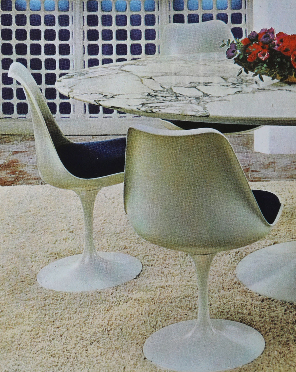 Mid-century modern tulip chairs with marble table in patio setting