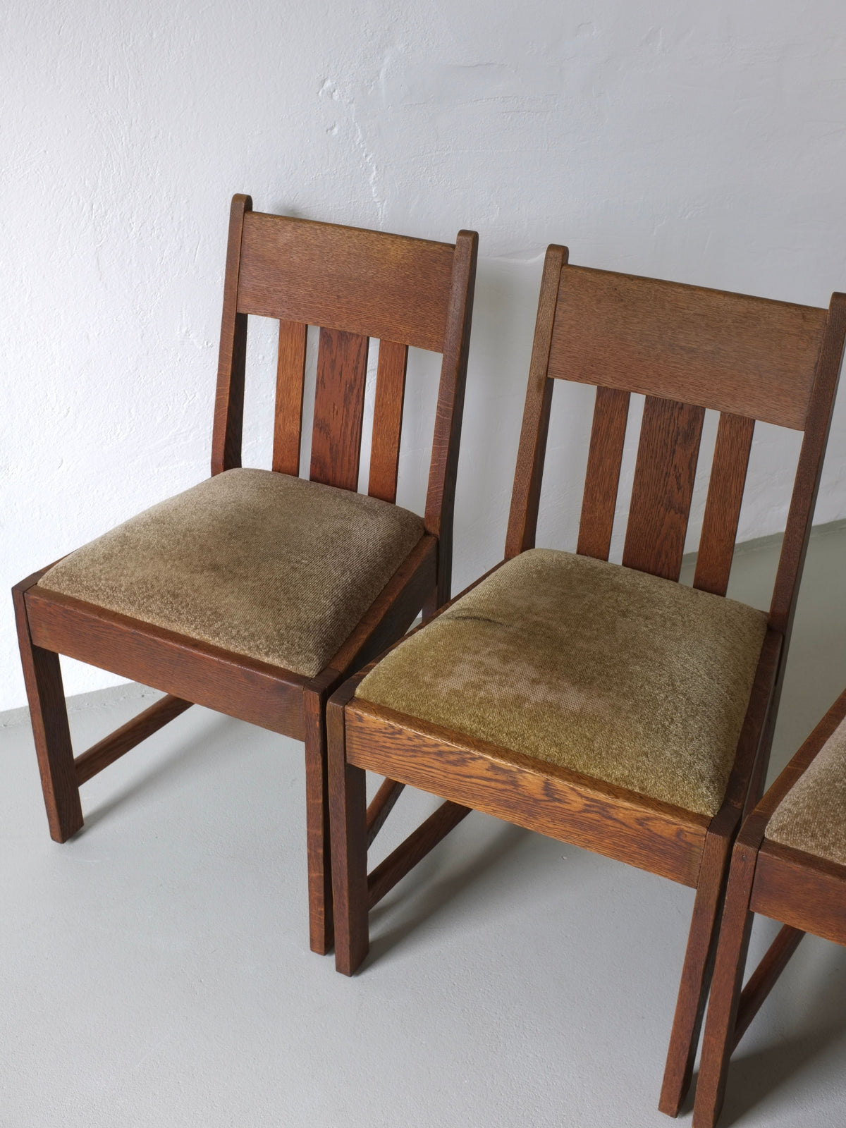 Two Arts & Crafts oak dining chairs with upholstered seats