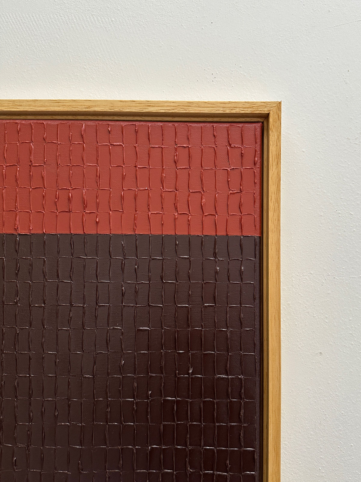 Textured grid painting detail showing red and brown segments
