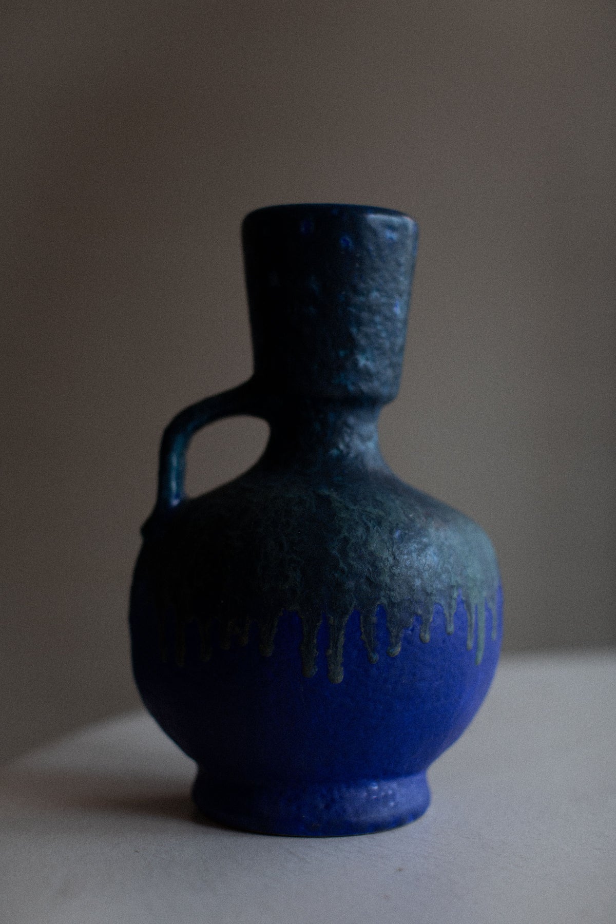 Old-fashioned metal vase with rusted patina and intricate filigree design