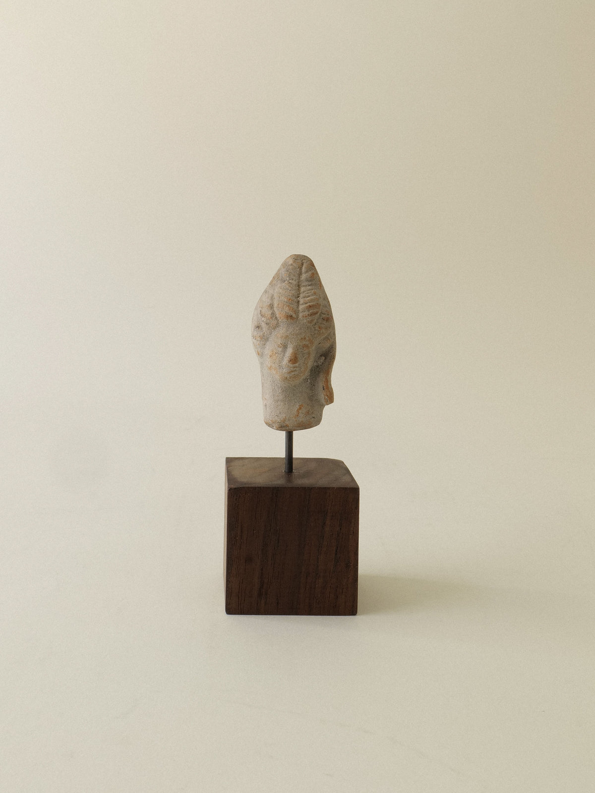 Ancient Hera sculpture head in weathered stone on wood base
