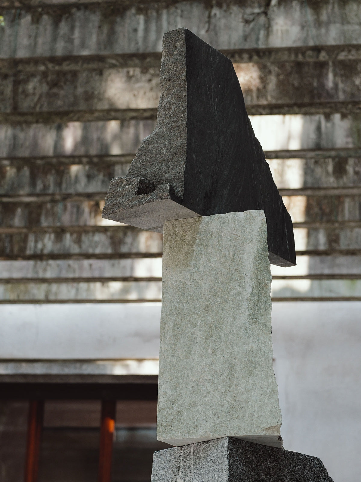 Contemporary stone sculpture with stacked geometric blocks in contrasting tones
