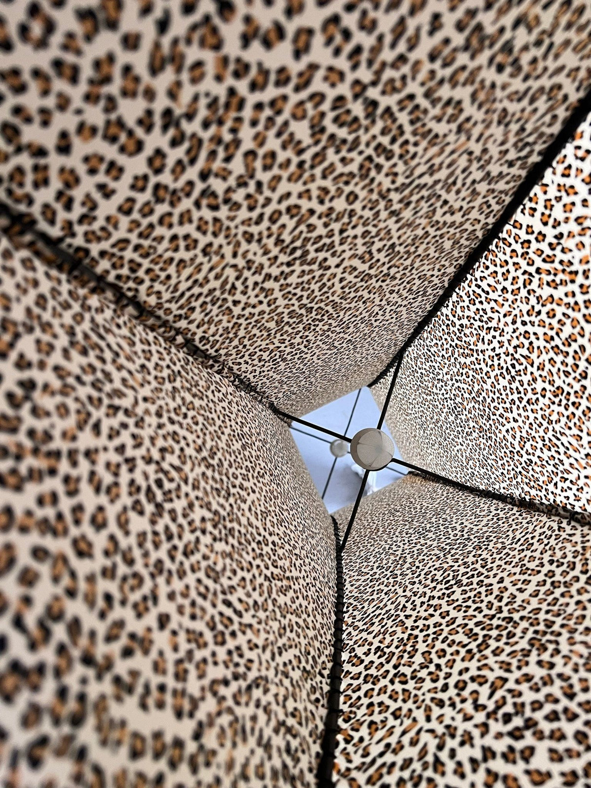Looking up from beneath the Veter Vintage Leopard Print Floor Lamp (1980s), you see the central pole and a hint of blue sky through its distinctive animal print fabric panels.
