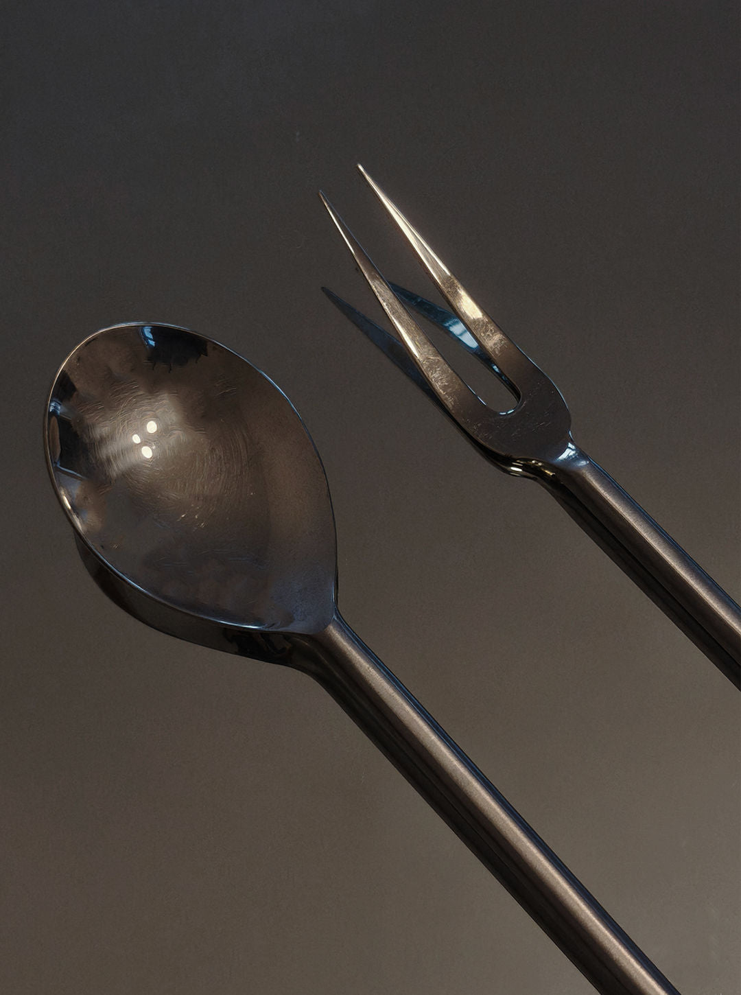 Elegant spiral serving spoon and fork set with dark metallic finish