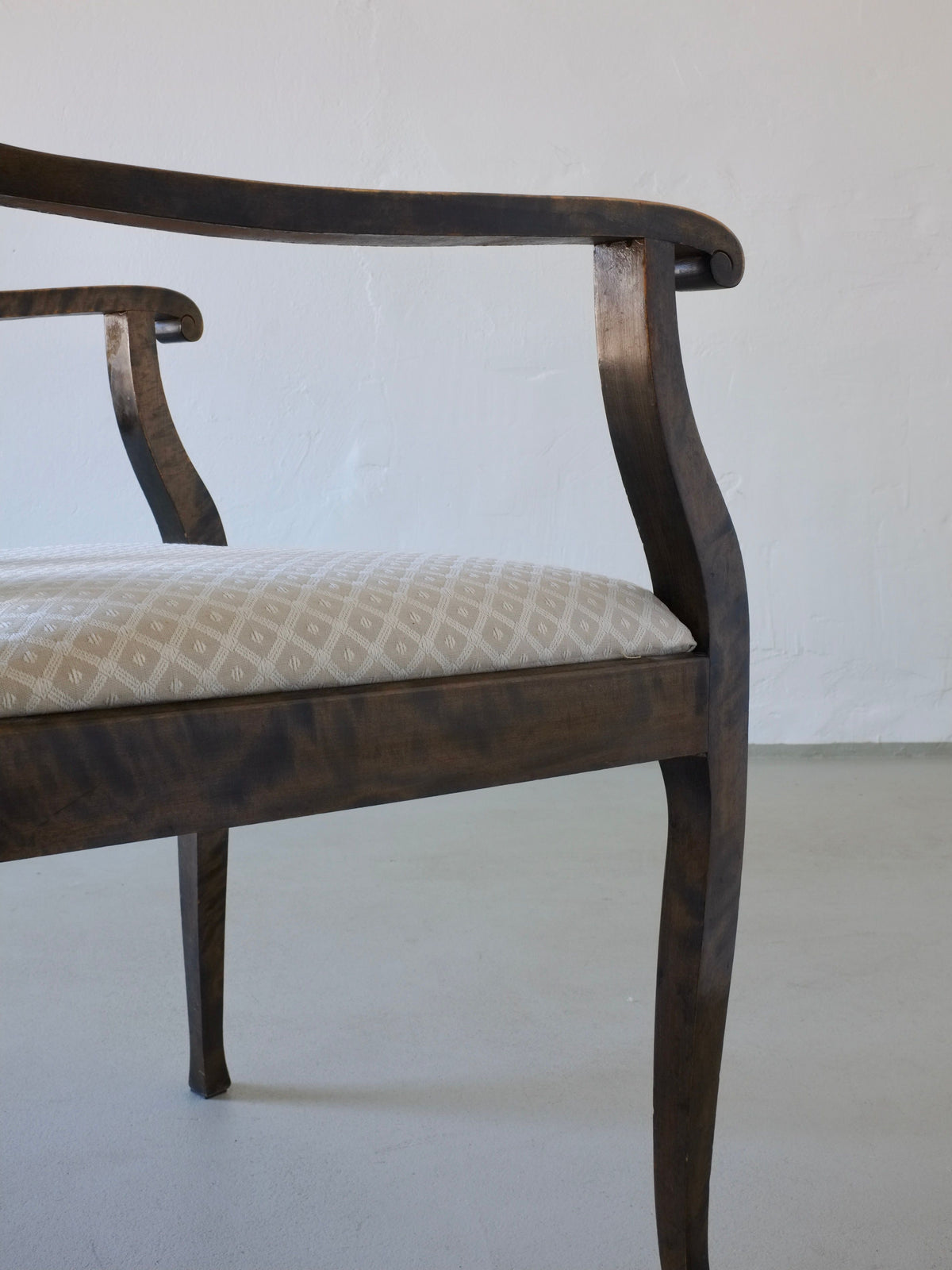Close-up detail of Swedish Grace satin birch dining chair armrest