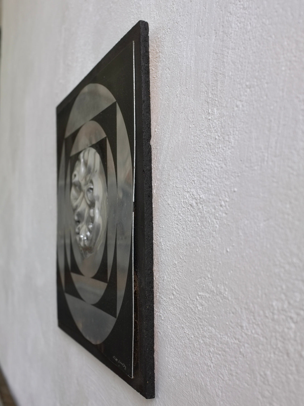 Geometric wall sculpture detail showing angular metallic surface layers