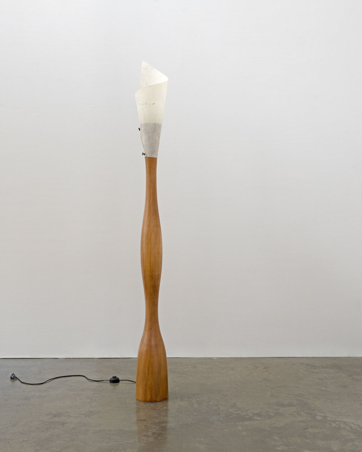 Tall sculptural wood floor lamp with white fabric shade by Tom Bogle