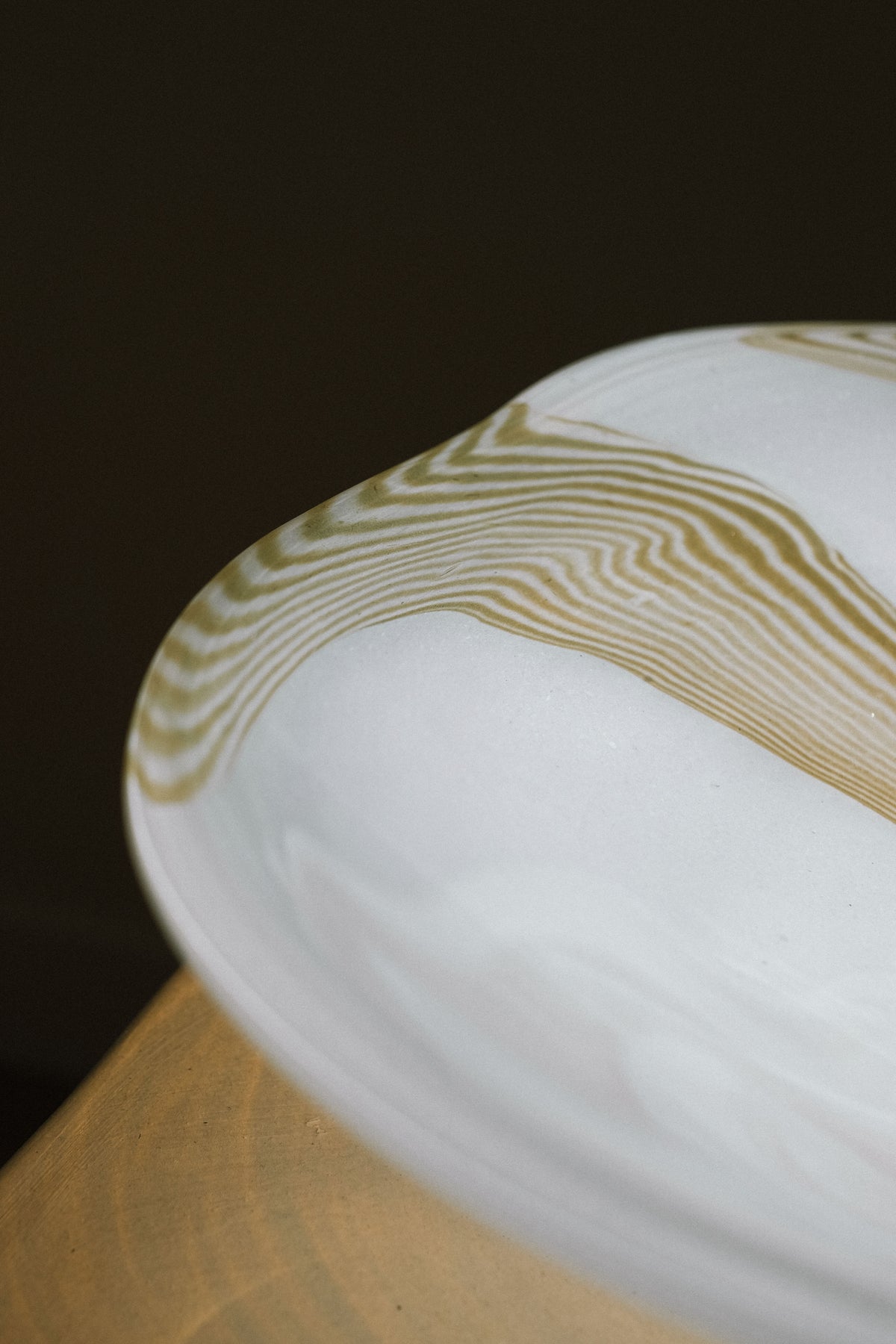 Large blown glass bowl with golden swirl pattern detail