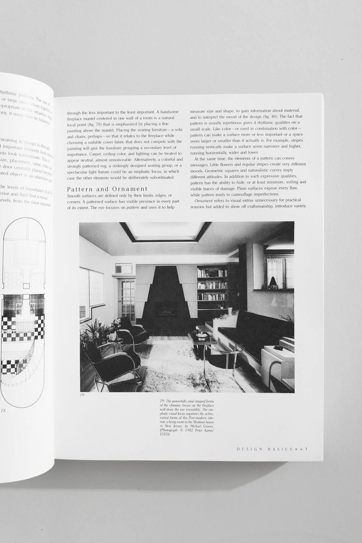 Interior design book open showing modern living room with fireplace