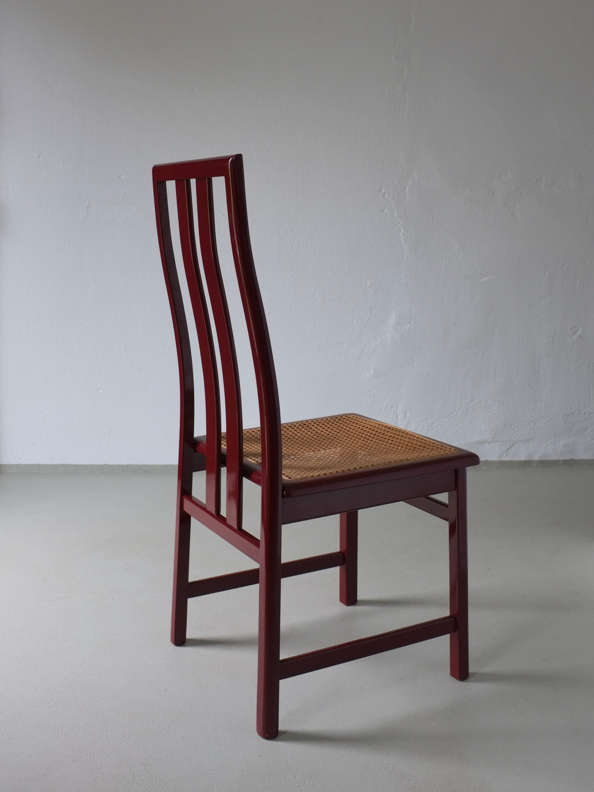 Wine red cane seat chair profile view, Italian 1970s vintage design
