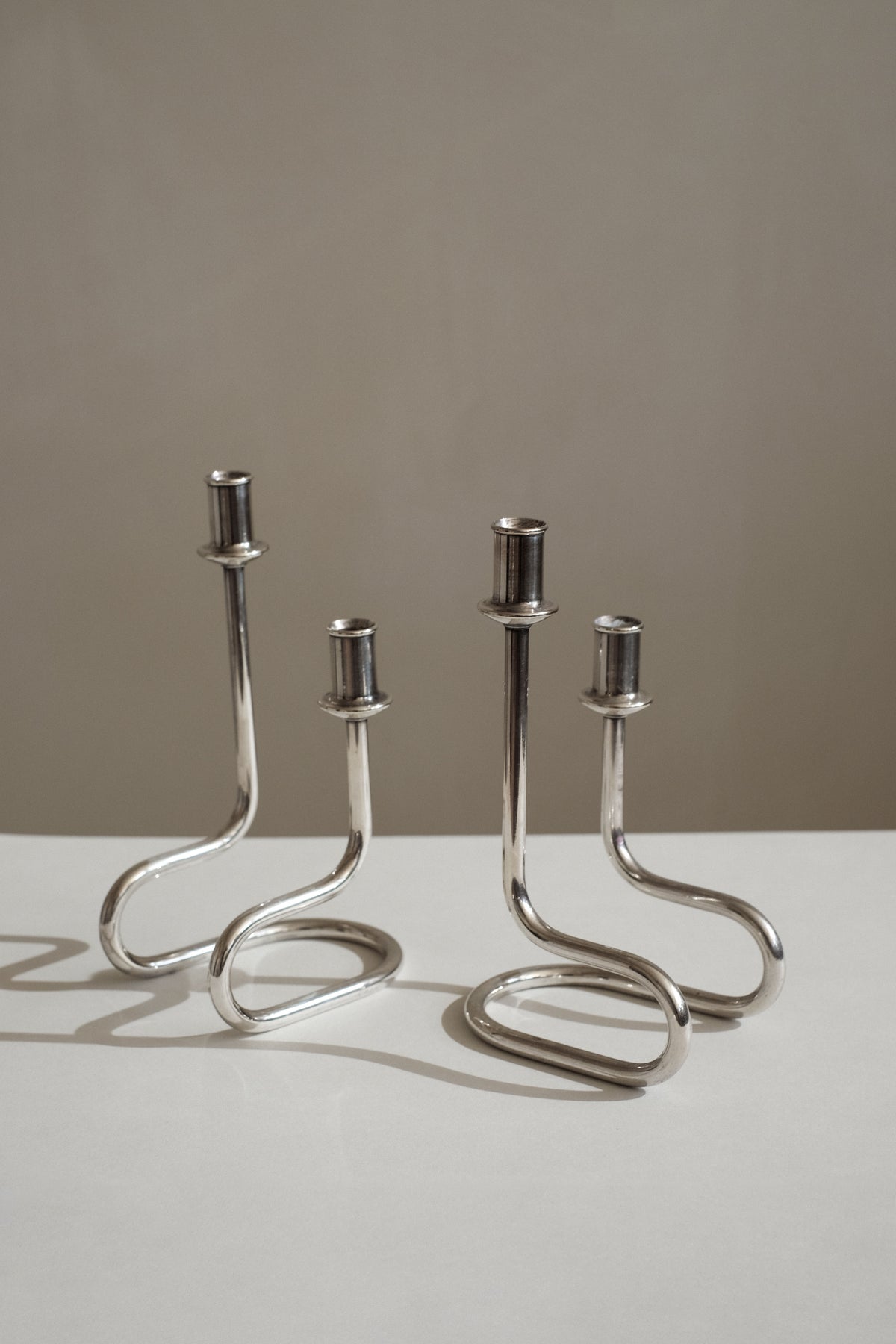 Modern chrome candleholders with curved serpentine stems by Gorham