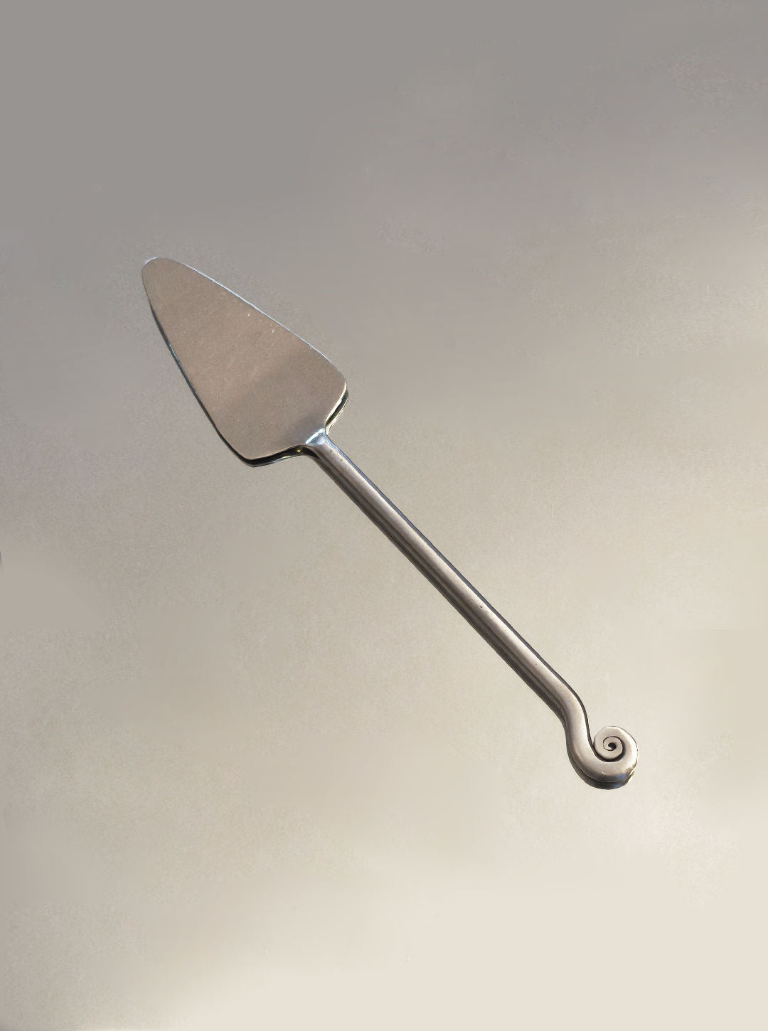 Stainless steel cake server with elegant spiral handle detail