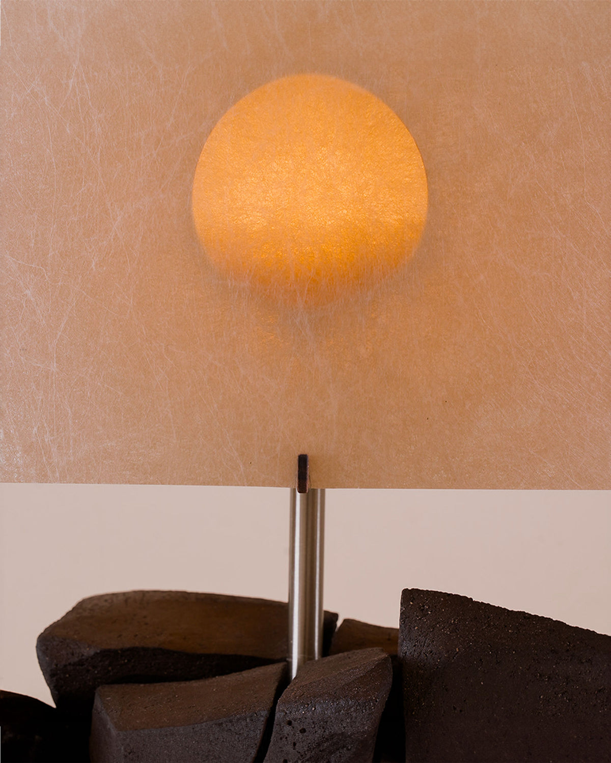Sunrise table lamp with orange sphere shade on textured base detail