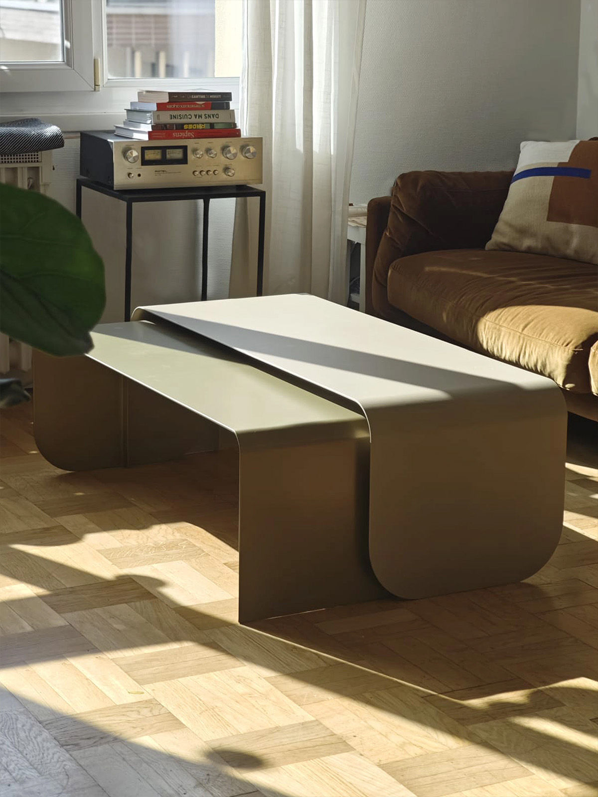 White curved metal coffee table in modern living room setting