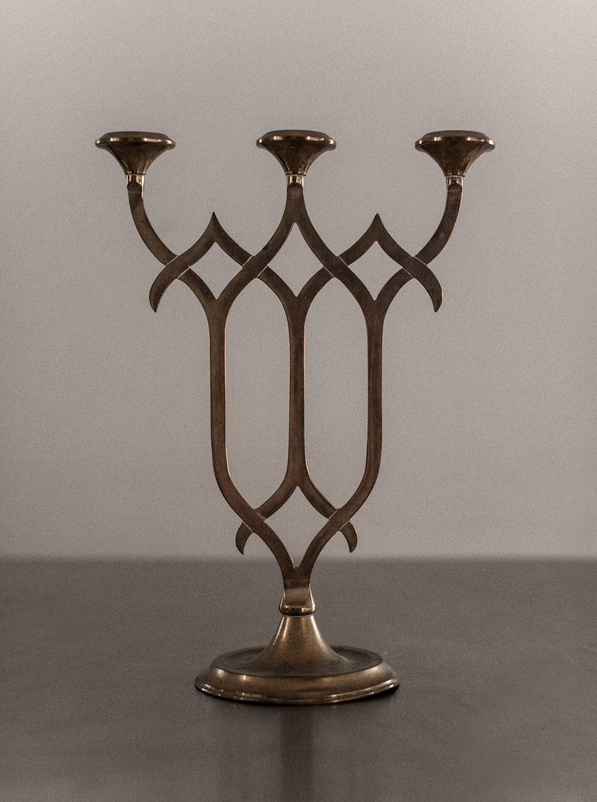 Elegant brass candleholder with tall, slender stem and round base