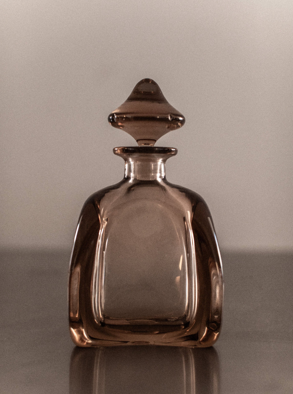 Antique crystal glass decanter with intricate diamond pattern and stopper
