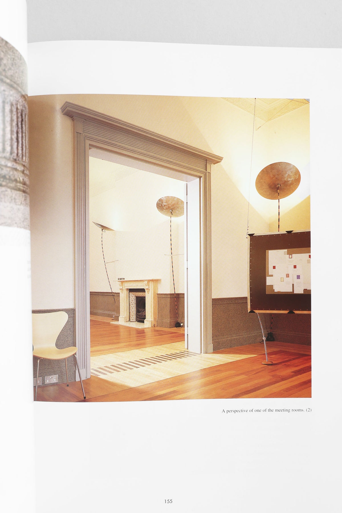 Discover inspiring minimalist office interiors in Villa’s 'Commercial Space: Offices, Design and Layout' book, featuring wooden floors, high ceilings, bold architecture, a fireplace, unique lighting, and functional furnishings.