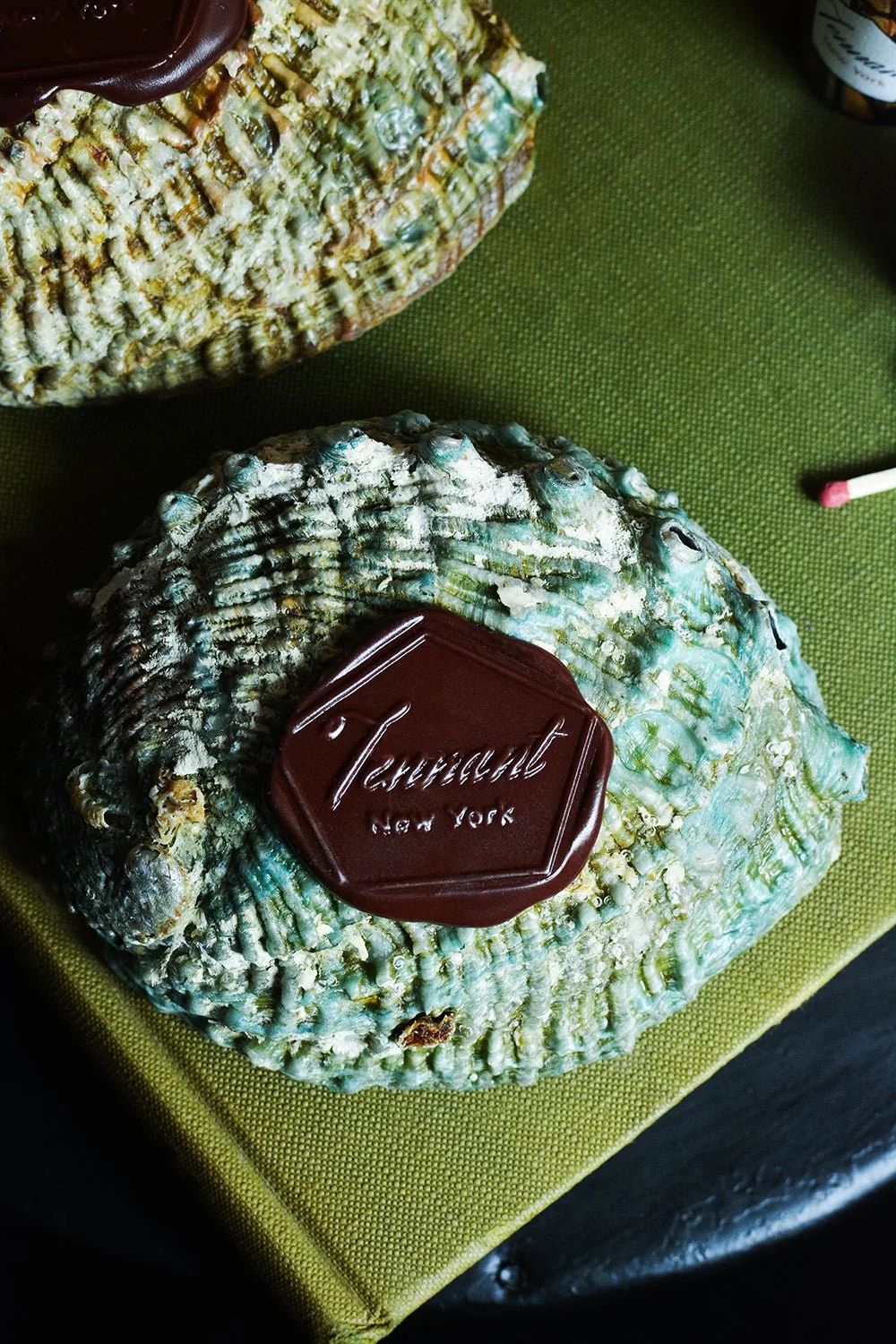 Abalone shells with brass Tennant New York incense holders on green mat