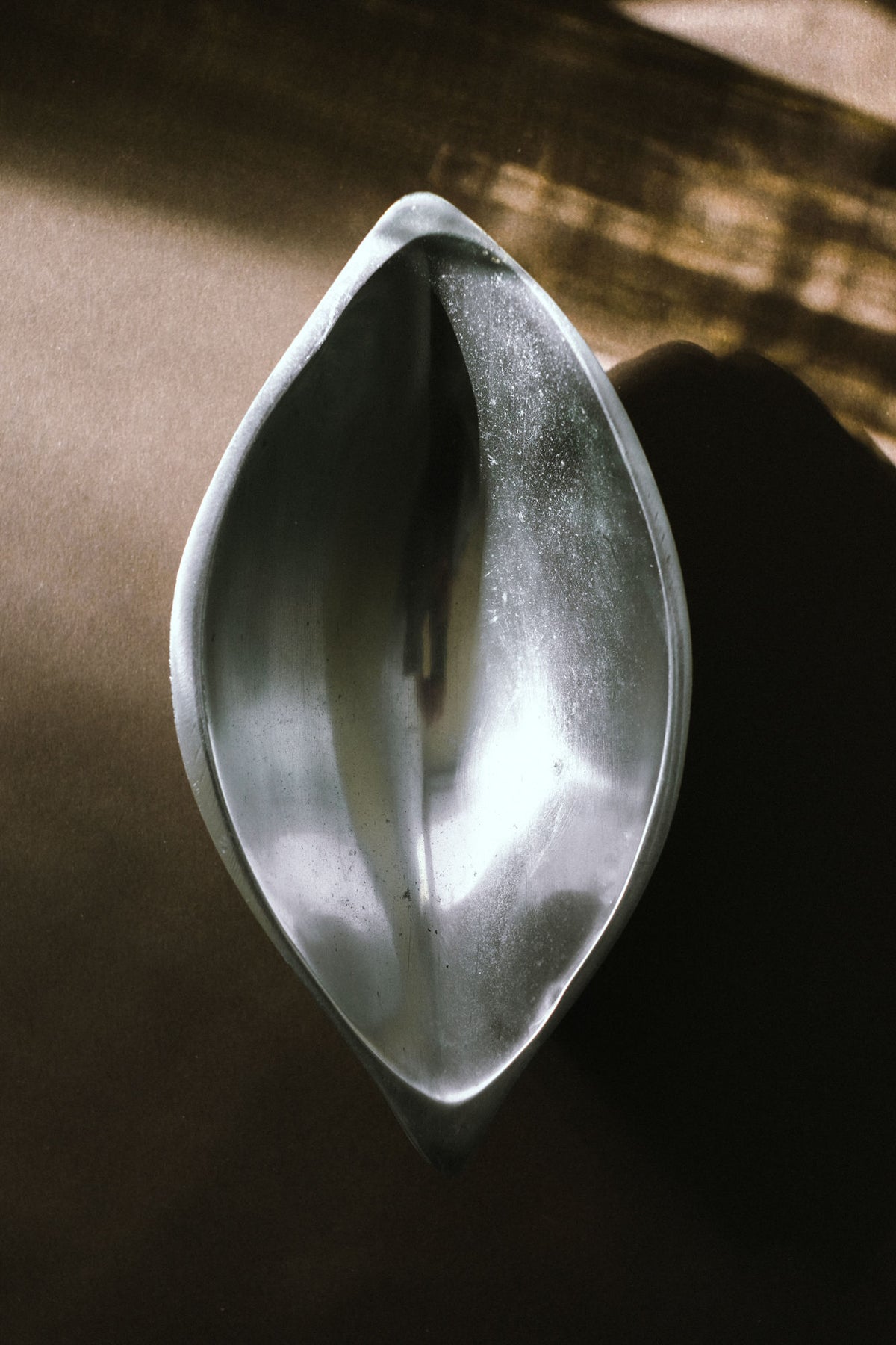 Minimalist ceramic serving dish detail showing sculptural oval form
