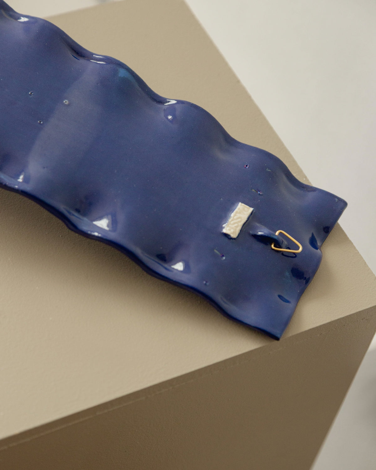 Blue ceramic rectangular candle sconce with scalloped edges detail