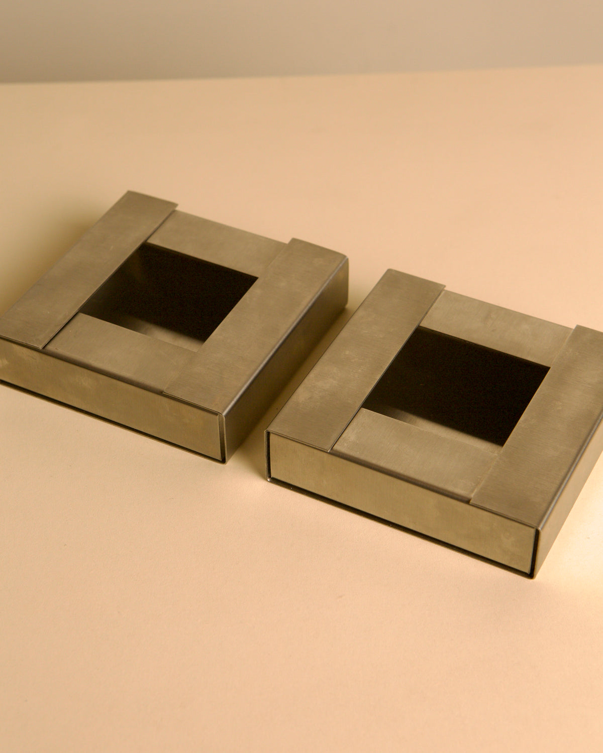 Pair of Italian brushed metal ashtrays by Fontana Arte, 1960s — alternate view
