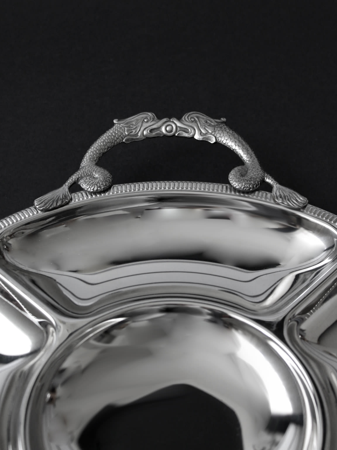 Ornate handle detail of vintage Couzon Orfèvre silver serving tray