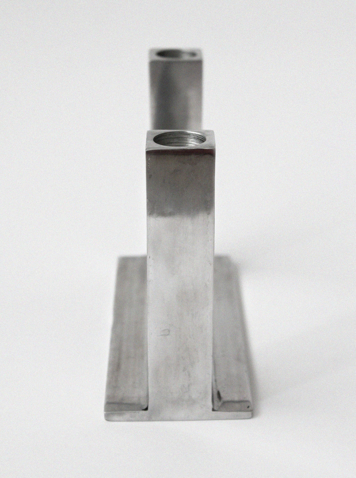 Brutalist aluminum candle holder side profile view