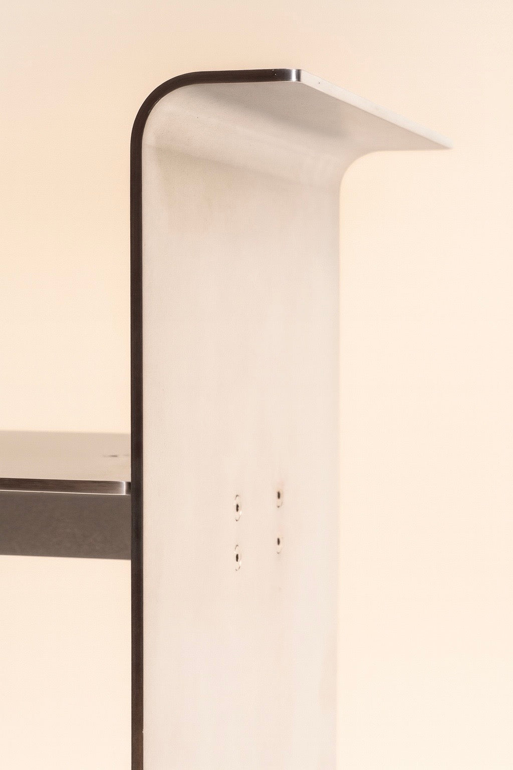 Close-up detail of DRY KISS aluminum chair curved backrest design