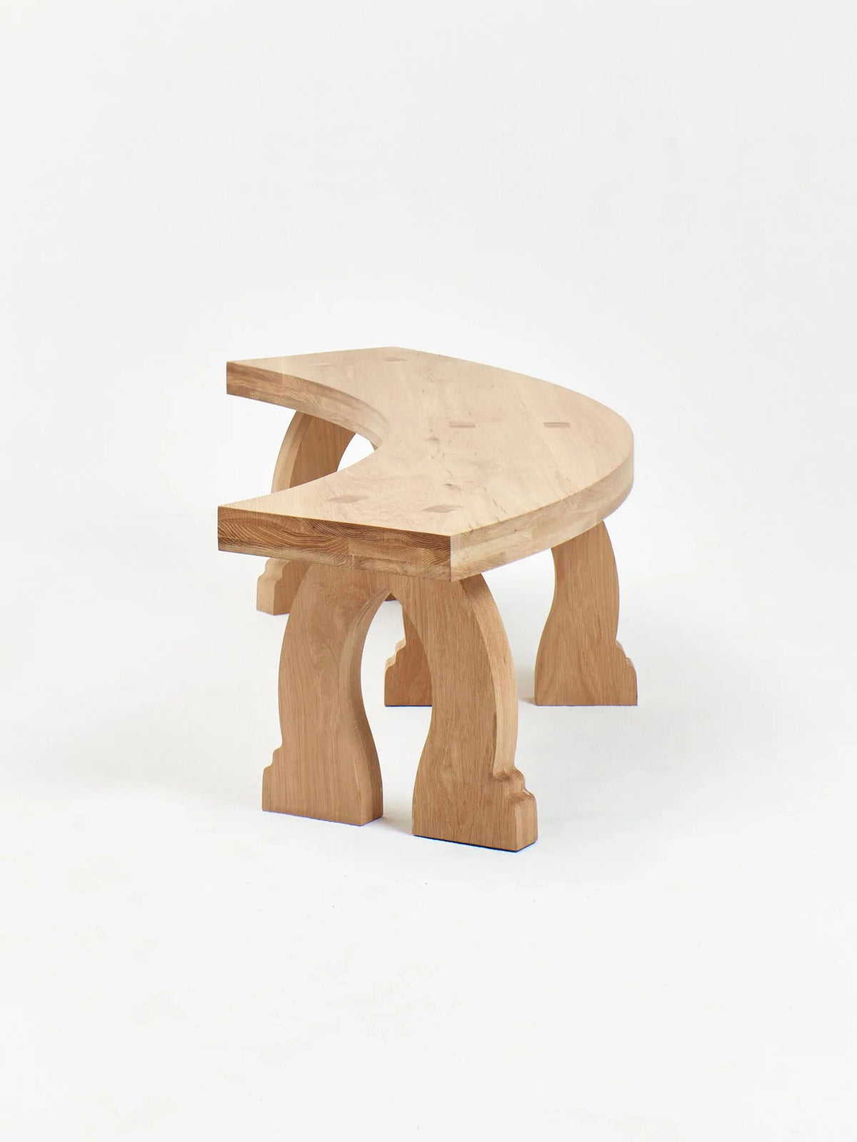 Sintra Curved Bench in Oak — angled view highlighting curved wooden legs