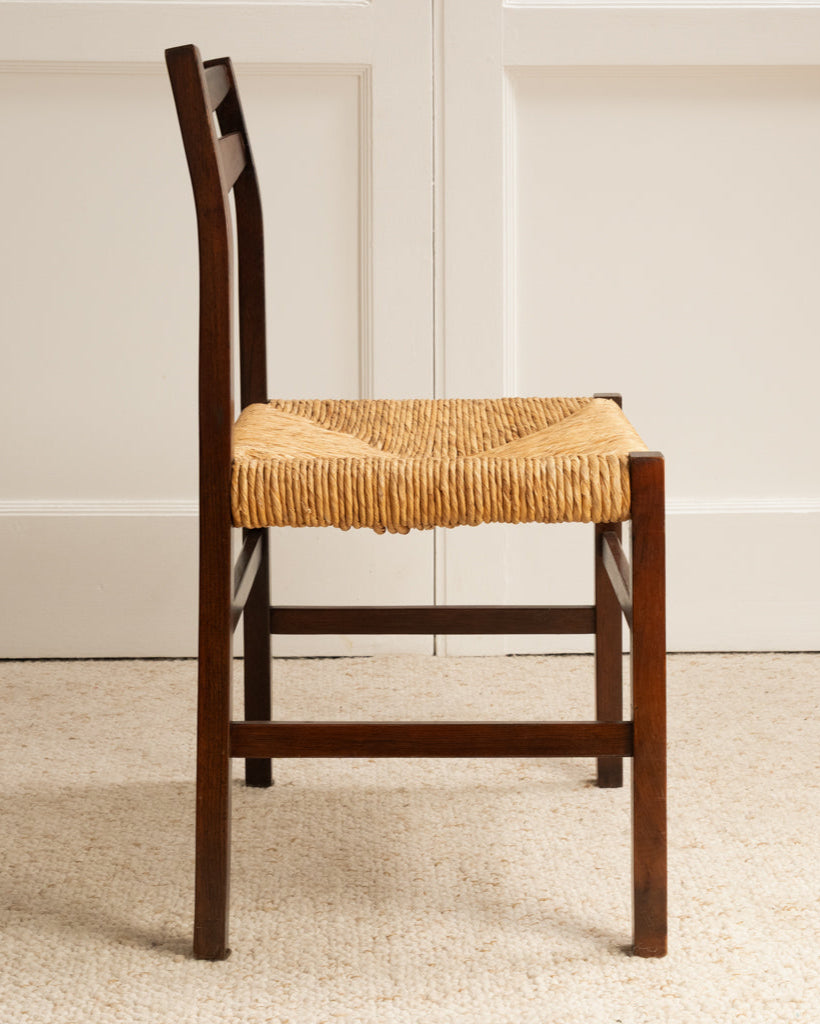 Side profile view of 1960s Italian wooden chair with woven rush seat