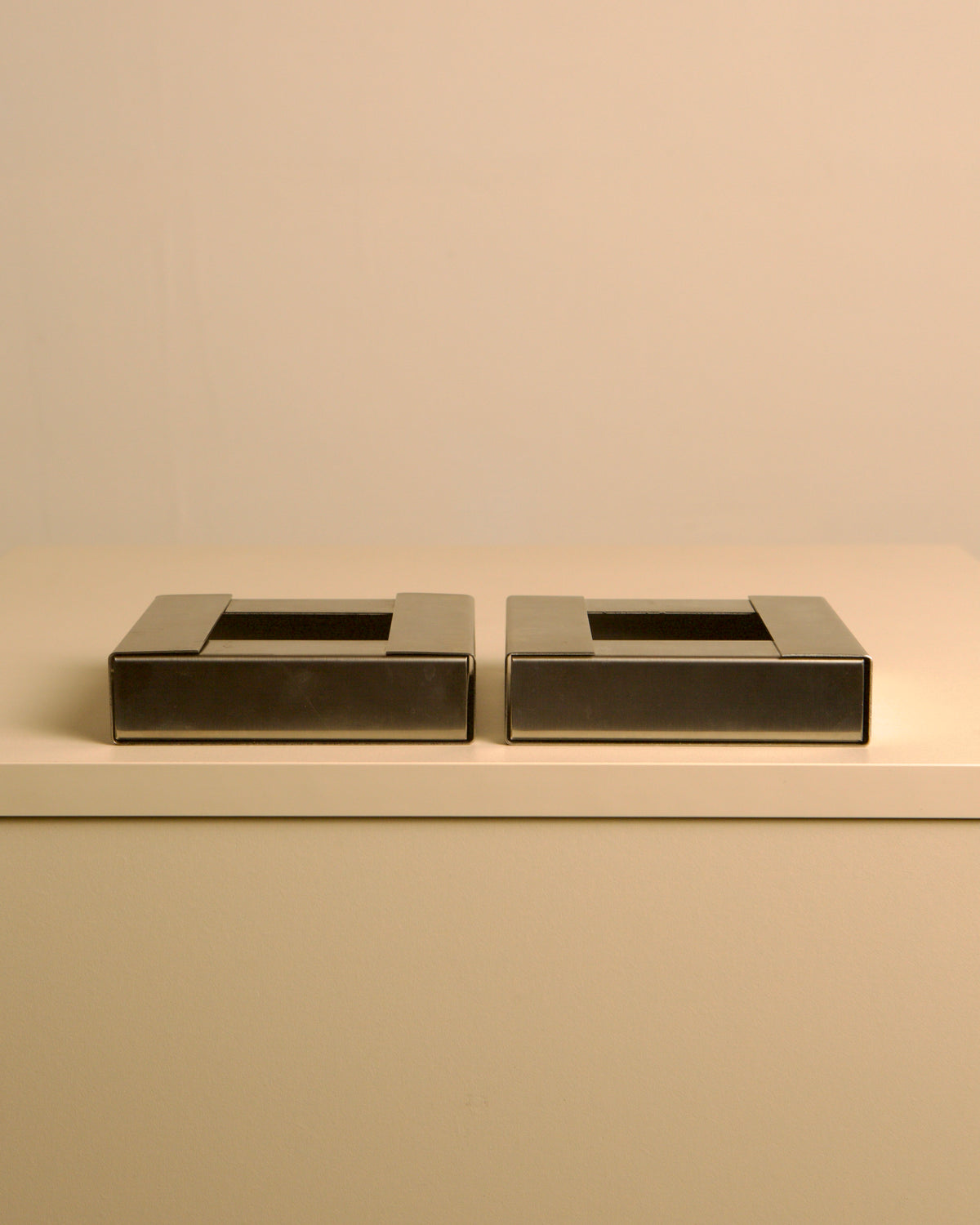 Pair of Italian brushed metal ashtrays by Fontana Arte, 1960s — lifestyle setting