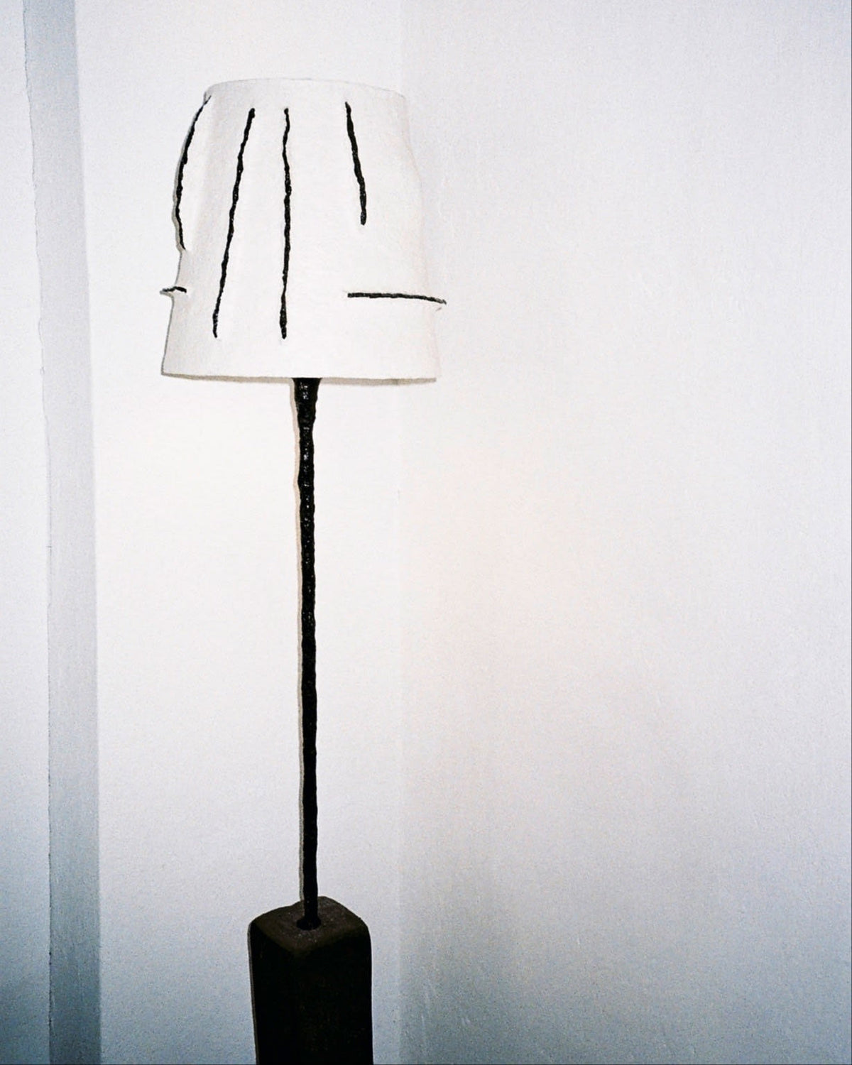 Rebirth II floor lamp with white shade and artistic black marks