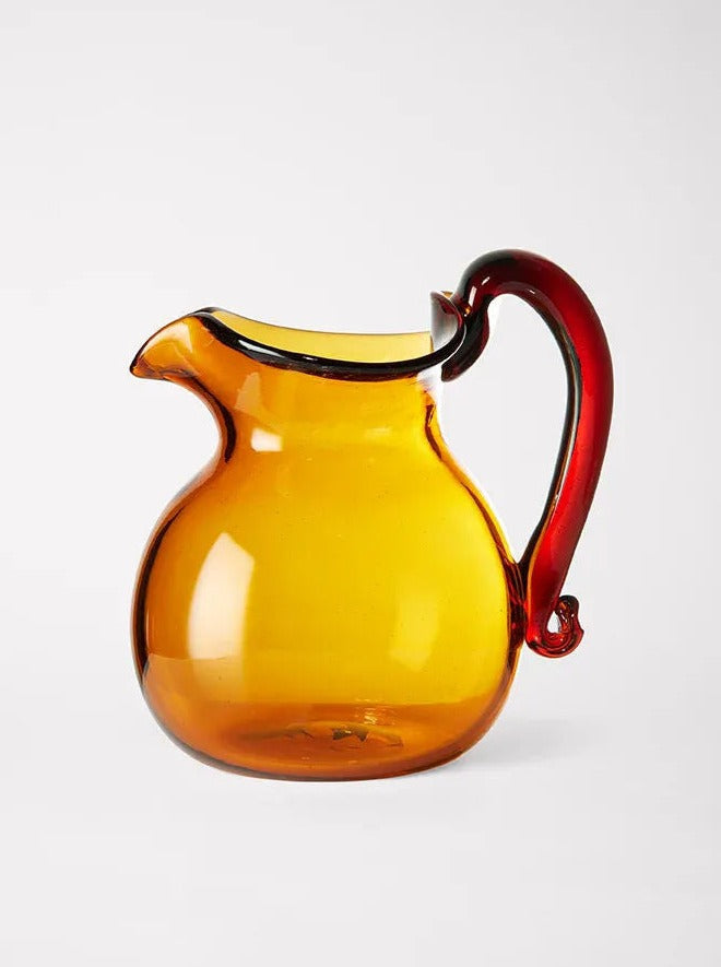 Blixen Jug — side angle showing amber glass and red handle
