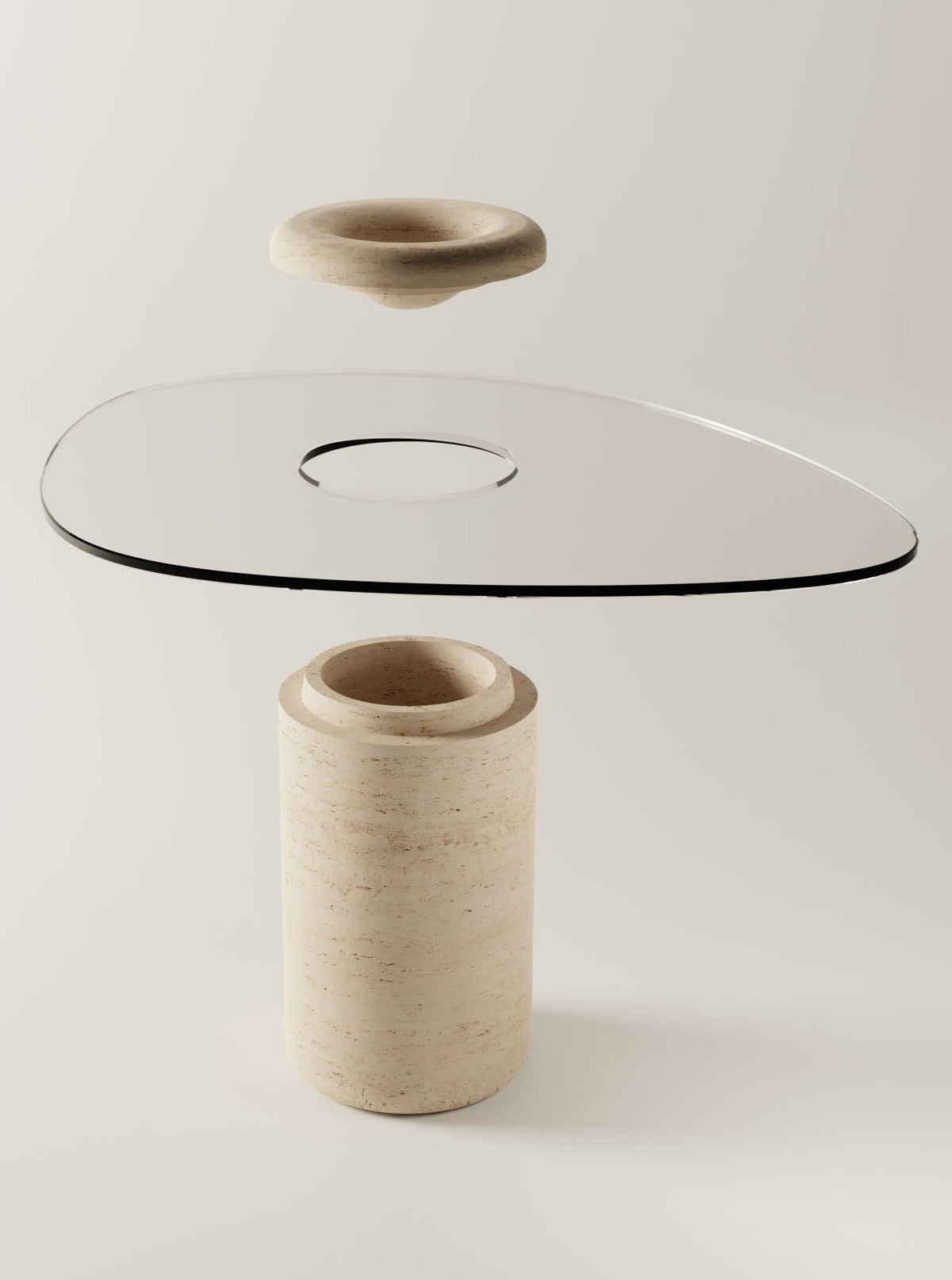 The BURGIO. UUFO 01 Dining Table features a glass top with an organic silhouette and central hole, set on a cylindrical stone base. A matching stone ring appears suspended above the glass, all against a minimalist neutral background.