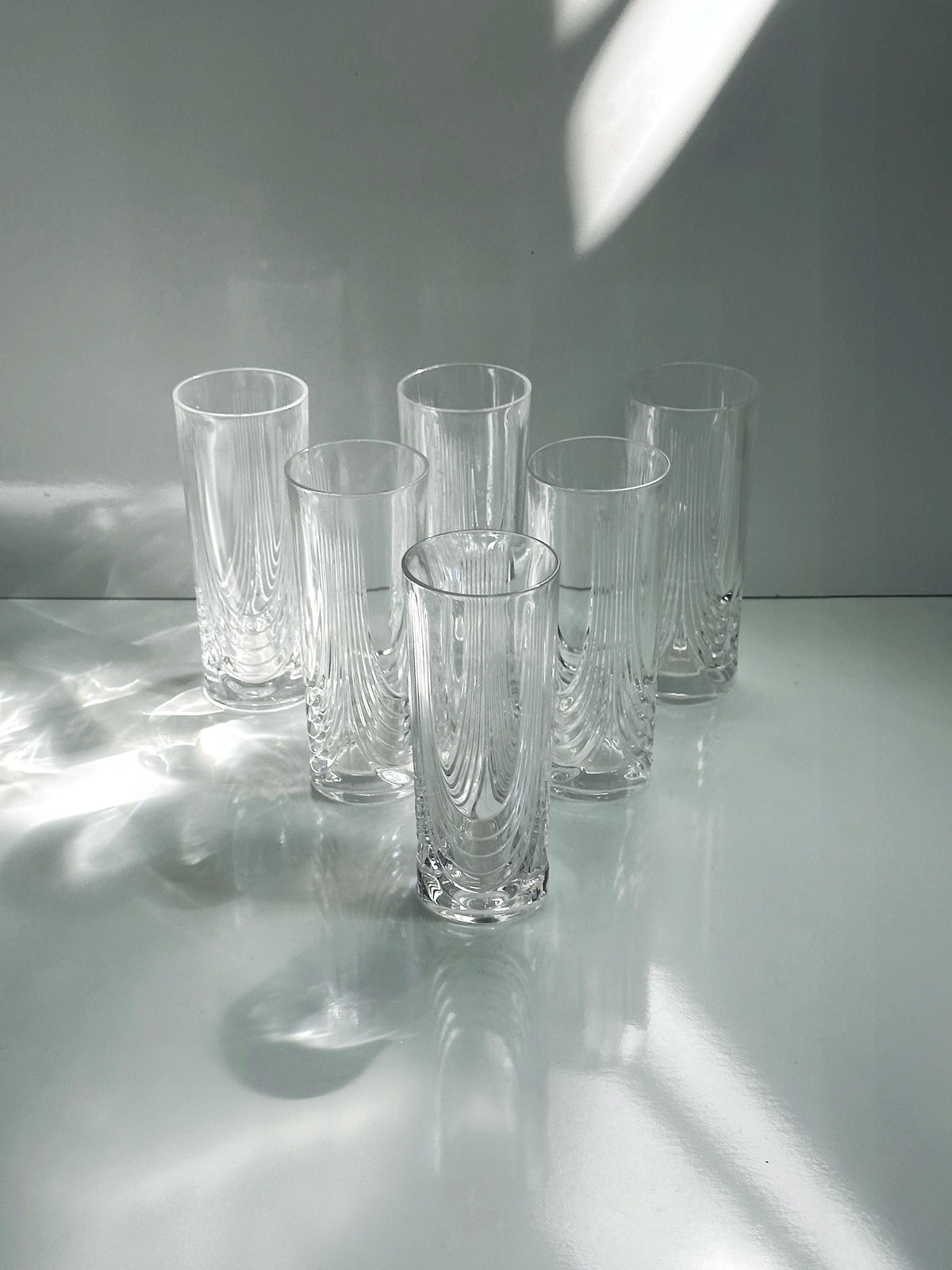 2 Italian Art Deco Crystal Glass Sets of 8 and 6 — close-up of clear glass texture on white surface