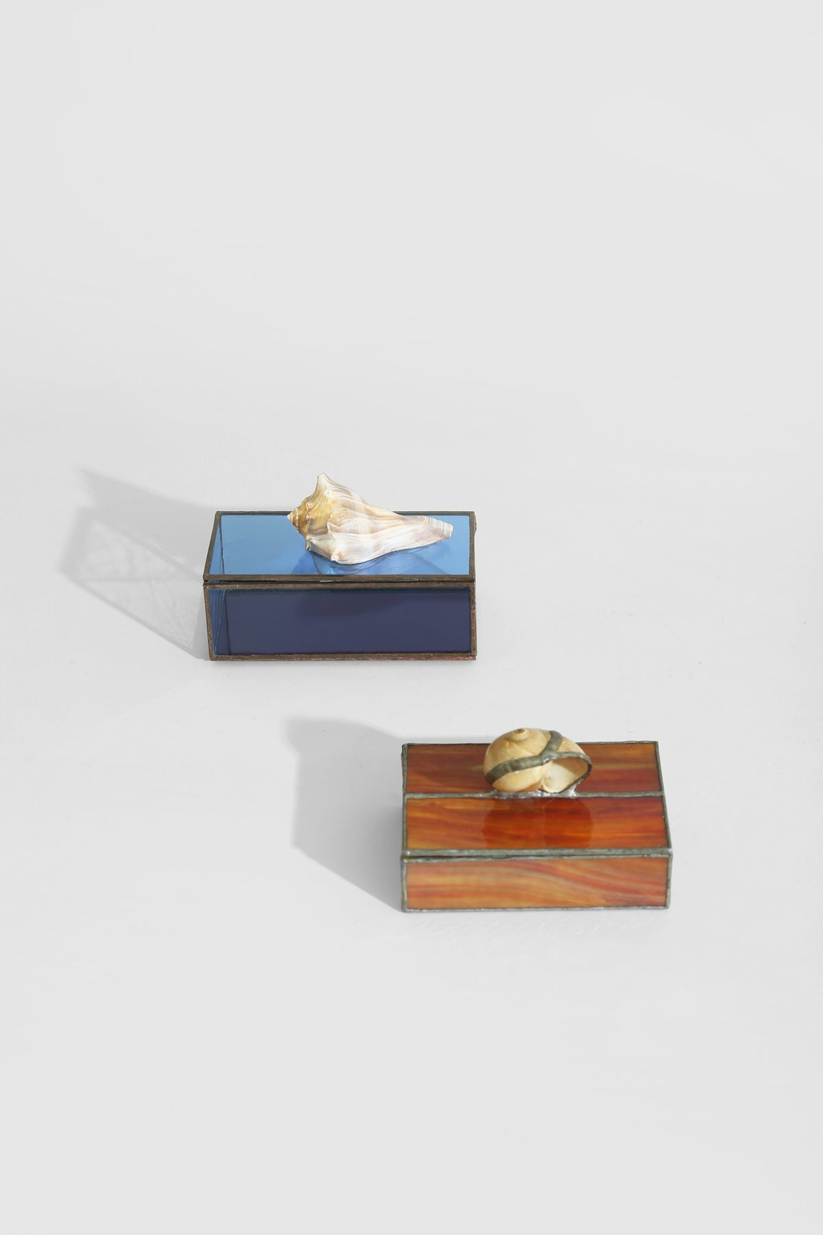 Shell Glass Jewelry Box — angled view showing blue and amber glass surfaces