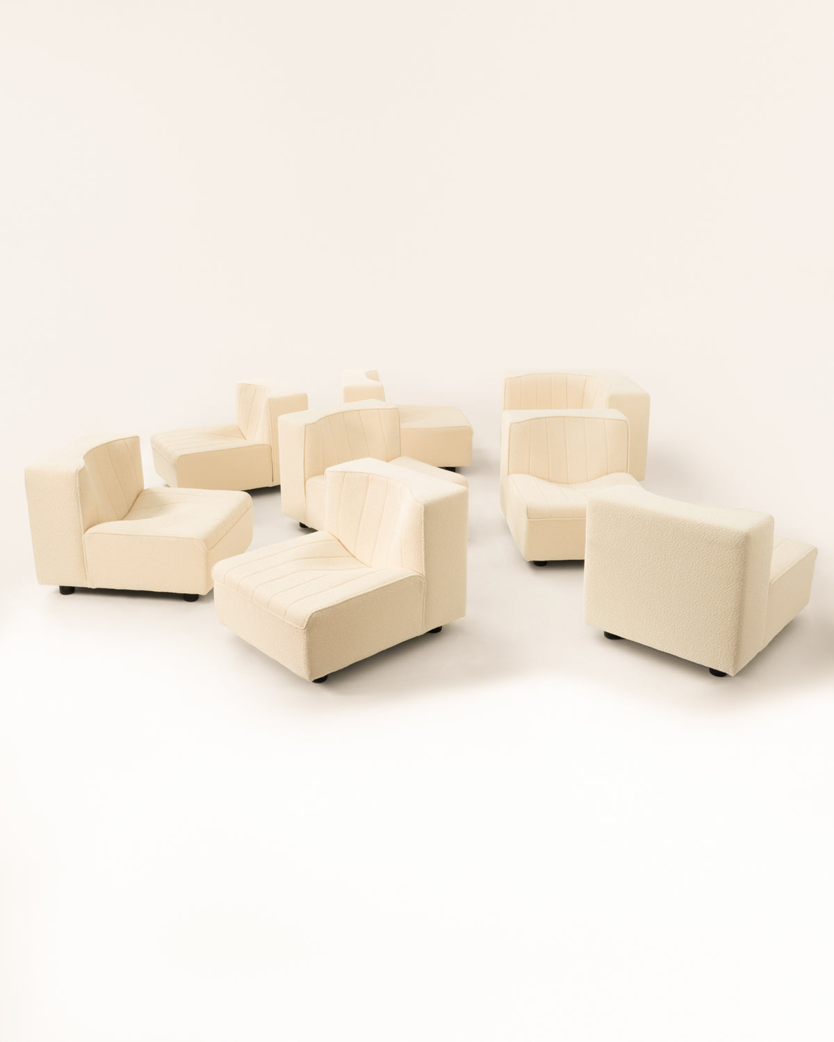 Cream modular sofa components arranged showing versatile configurations